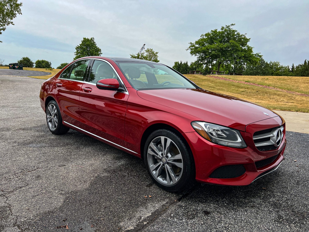 Red Mercedes-Benz sedan getting commercial fleet detailing on an outdoor lot in York, PA
