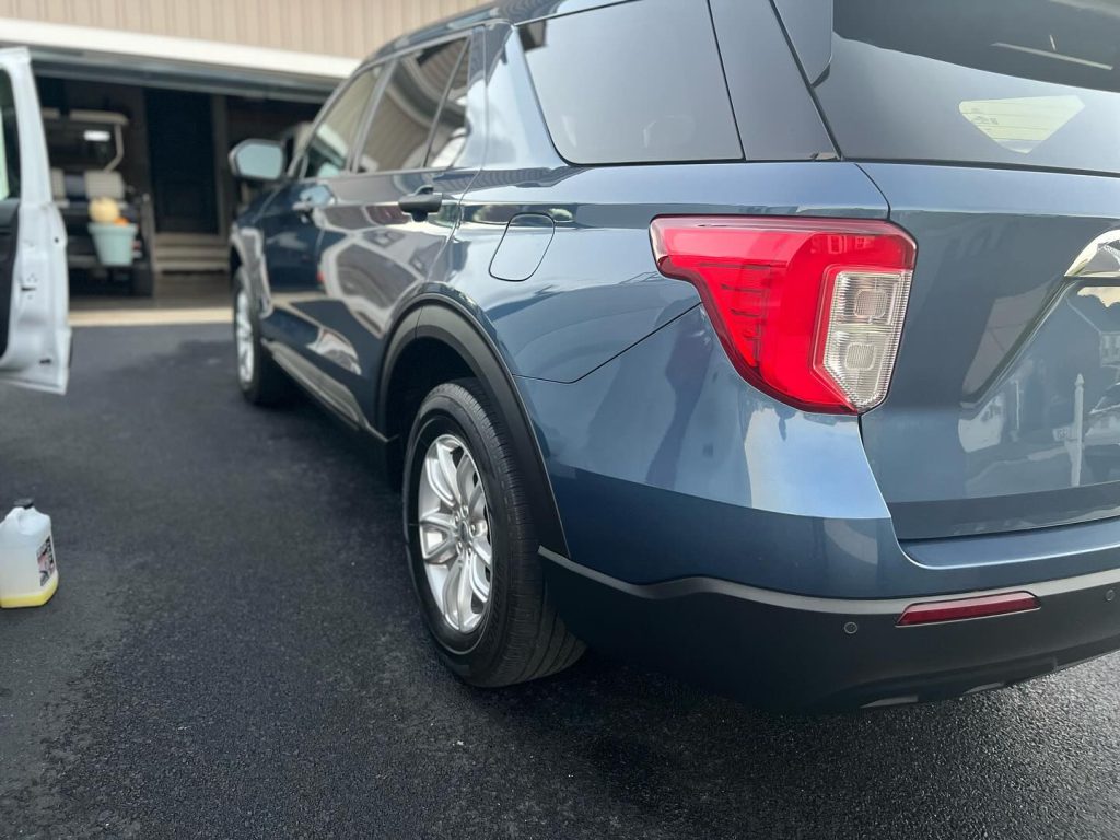Rear view of a dark SUV with fresh ceramic coating in a York, PA shop bay by Teddys Detail